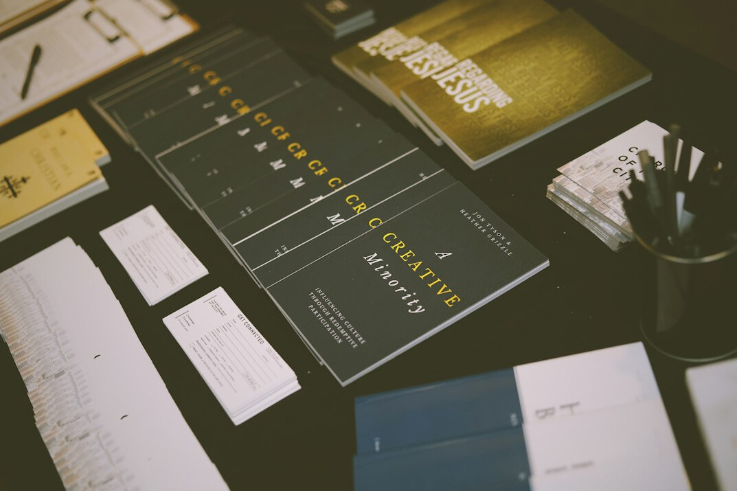 Printed planning documents and a pen on a wooden desk