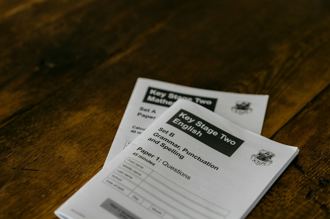 Printed summary documents stacked on a table